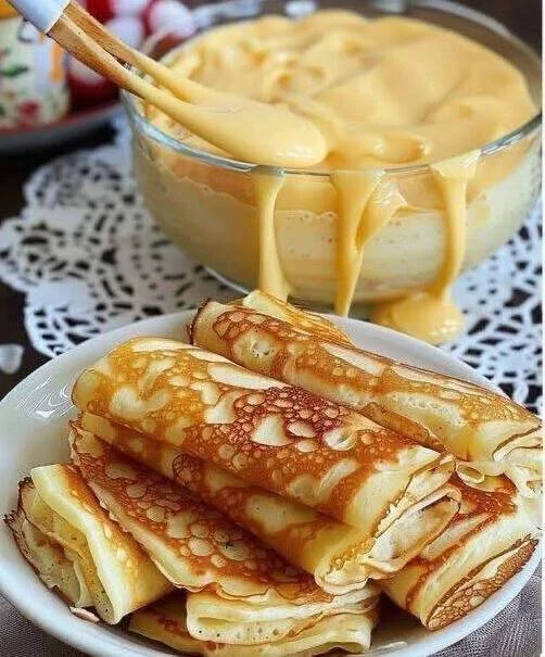 Delicious quark pancakes served with fruit and syrup on a plate