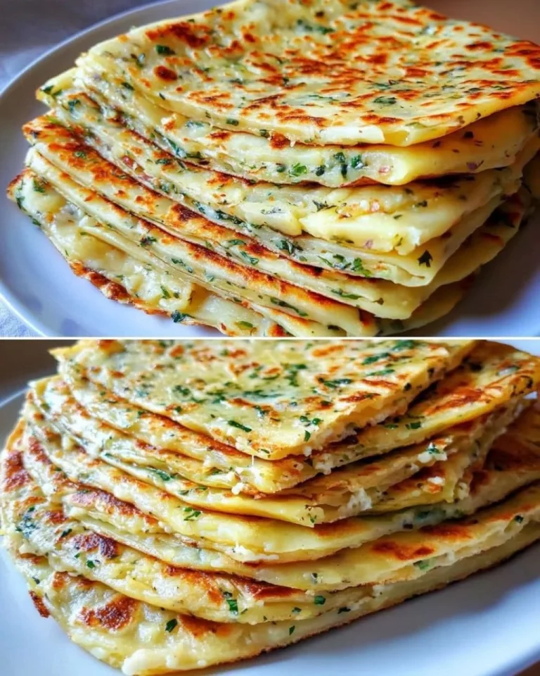 Layered potato flatbread with cheese and herbs on a wooden table