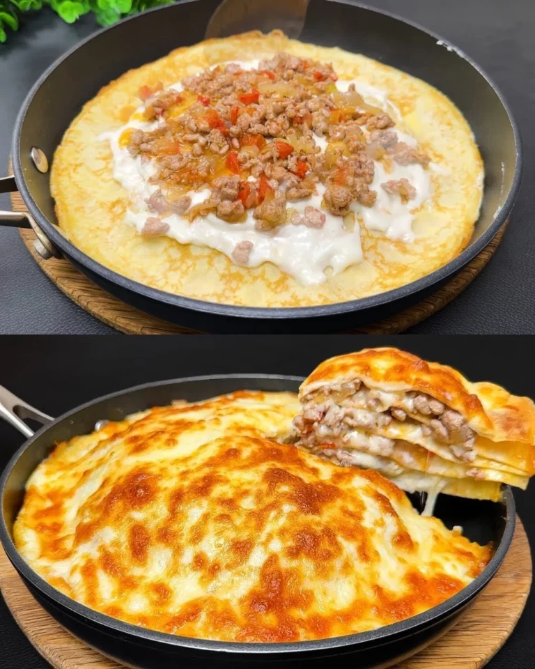 Savory pancakes with meat filling and béchamel sauce on a plate