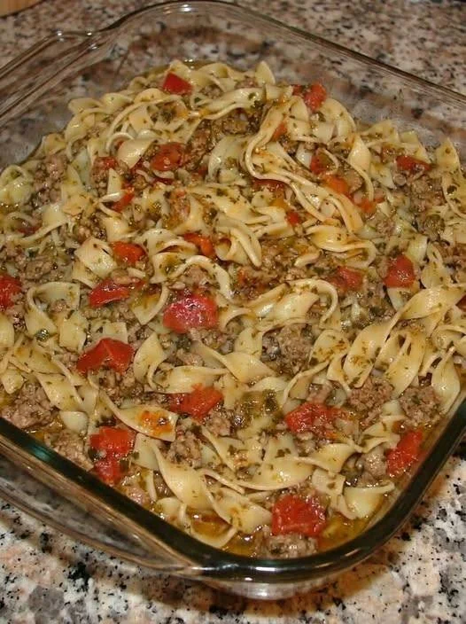 Delicious plate of Italian Sausage and Peppers Pasta garnished with herbs