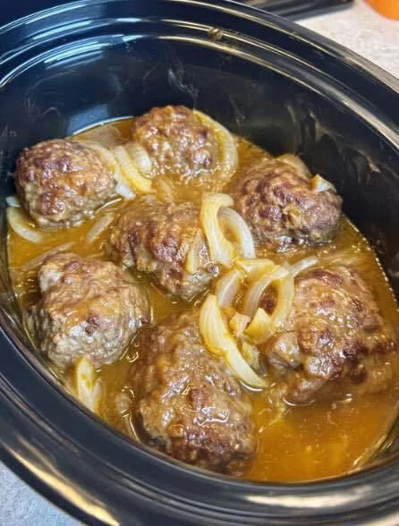 Delicious slow cooker Salisbury steak served with gravy and mashed potatoes