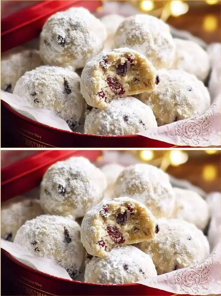 Delicious snowball cookies with cranberries and orange zest, dusted with powdered sugar.