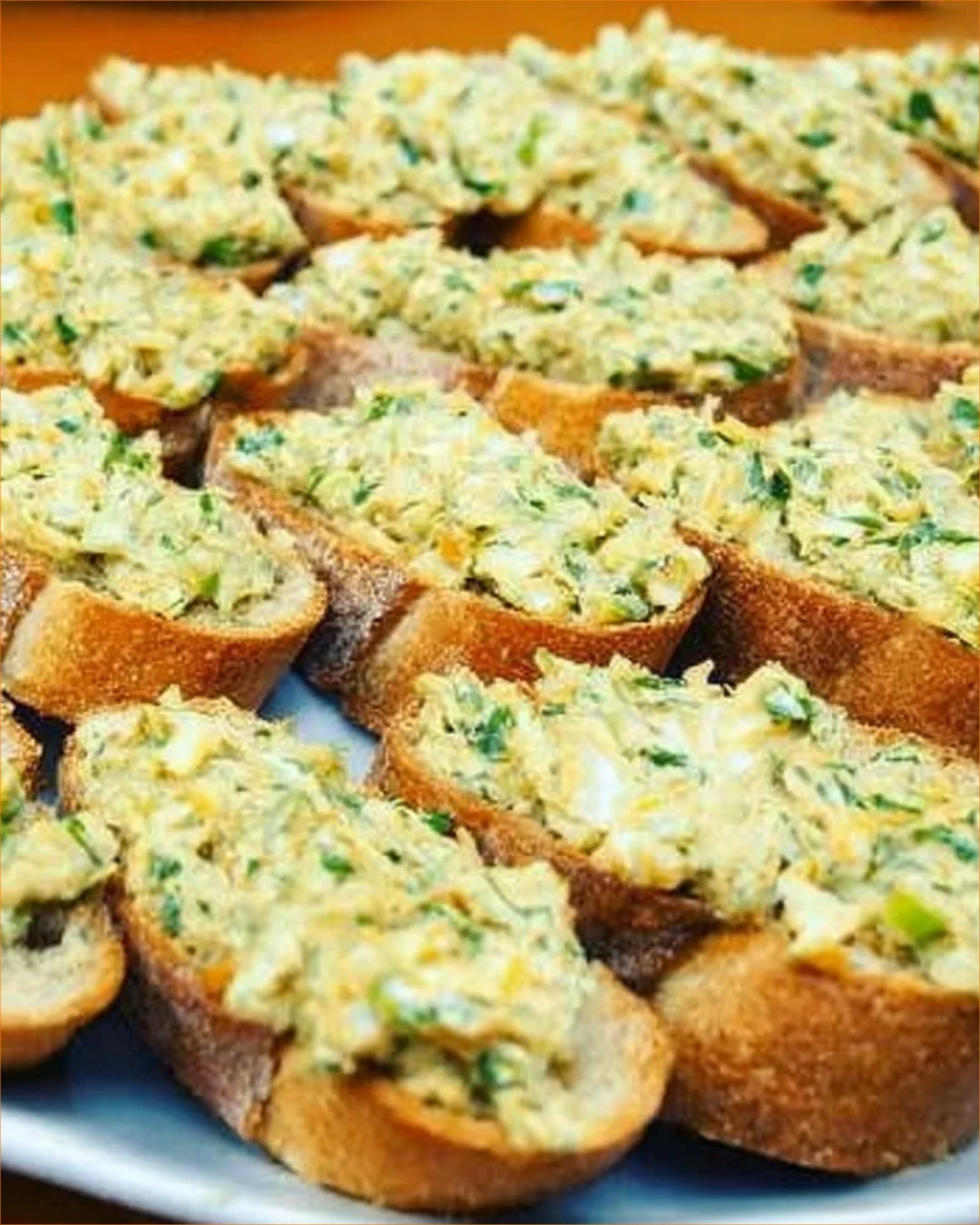 Plate of avocado and egg appetizers garnished with herbs