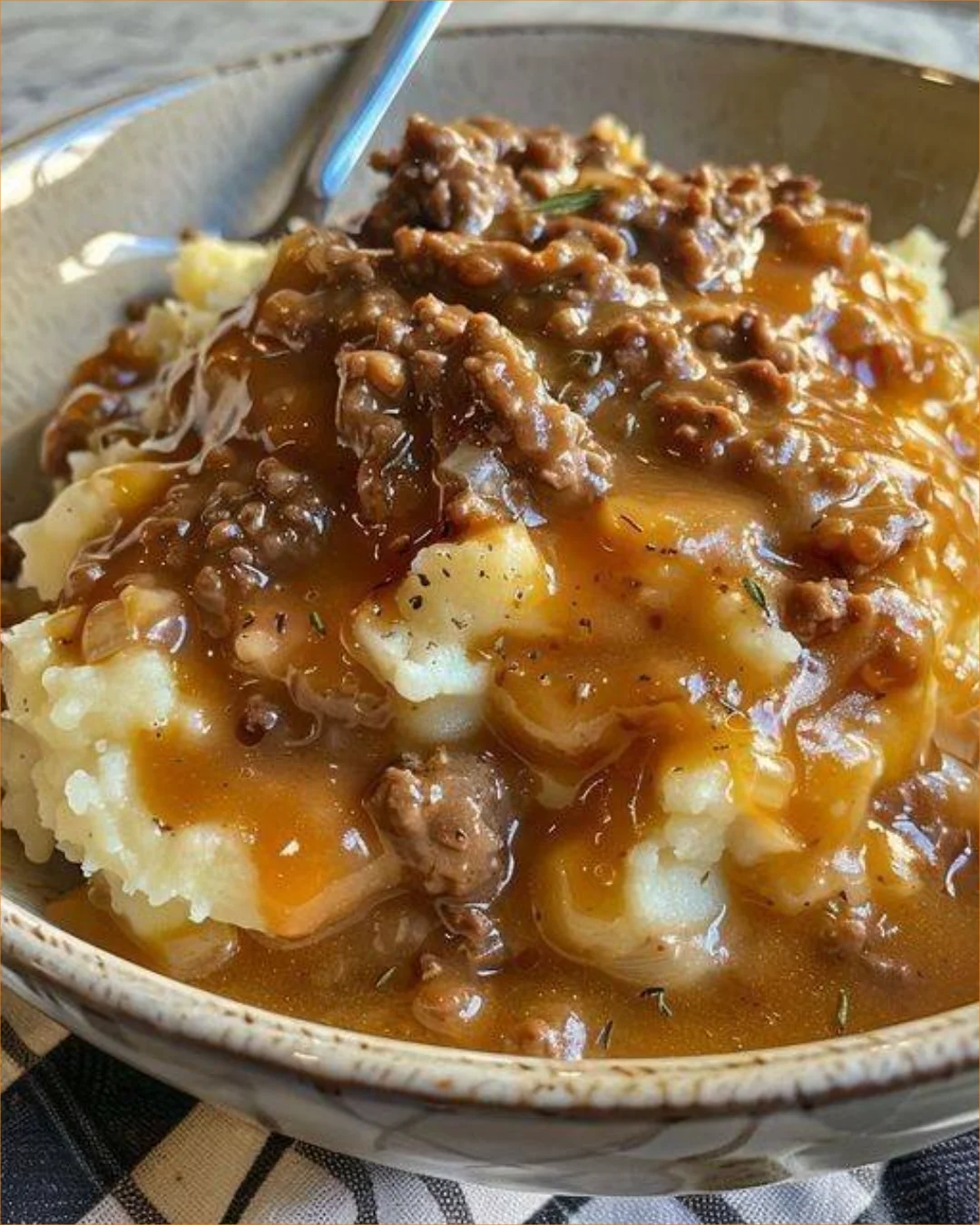 Creamy mashed potatoes served with savory beef gravy on top.