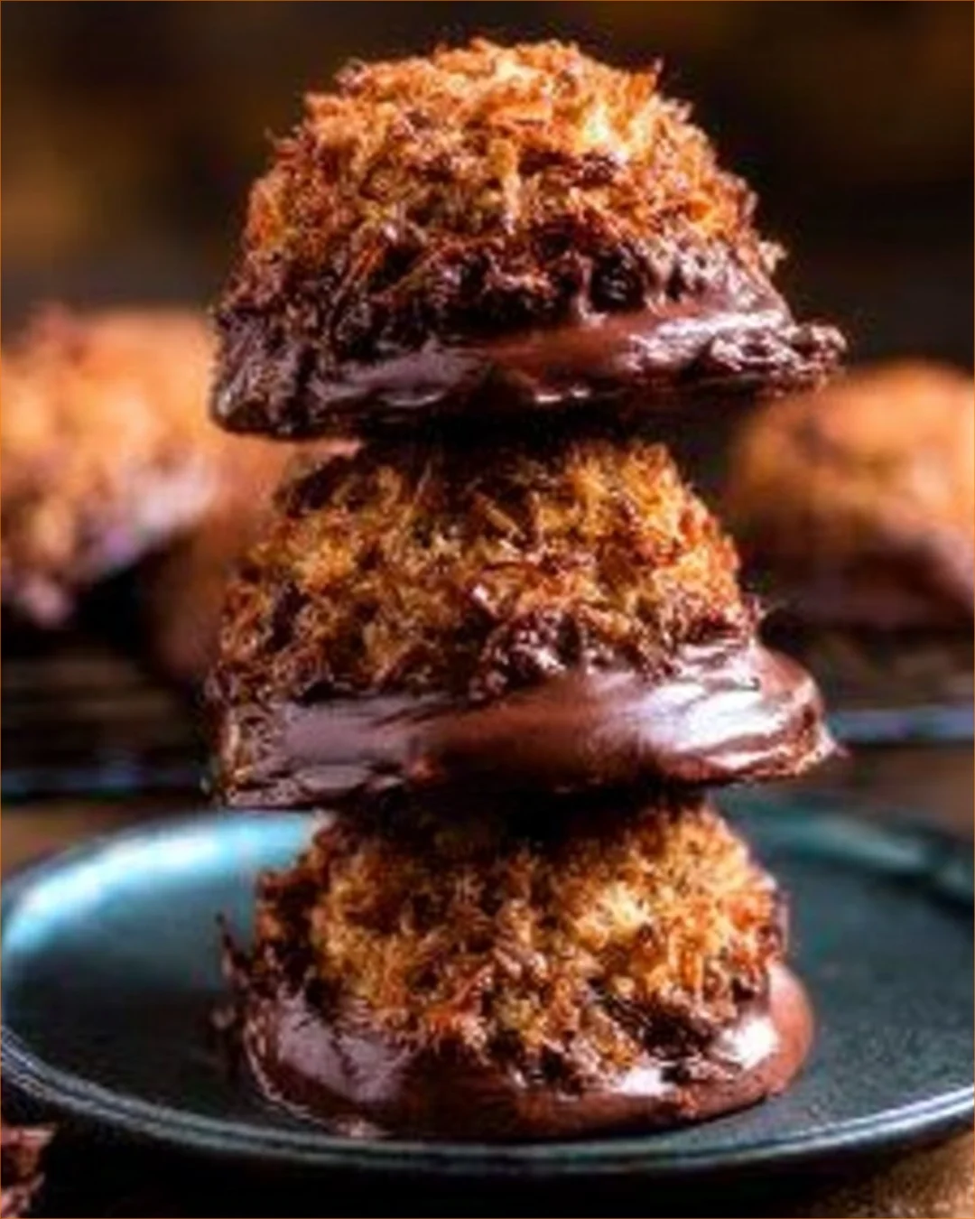 Flourless chocolate coconut cookies stacked on a plate