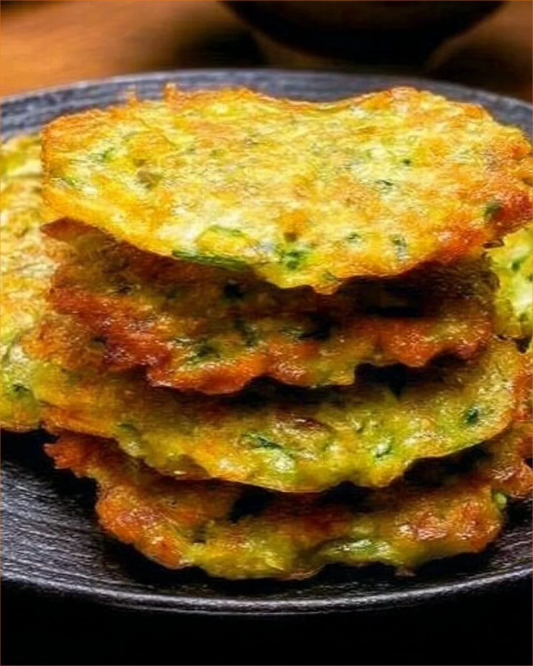 Healthy oatmeal and zucchini pancakes stacked on a plate