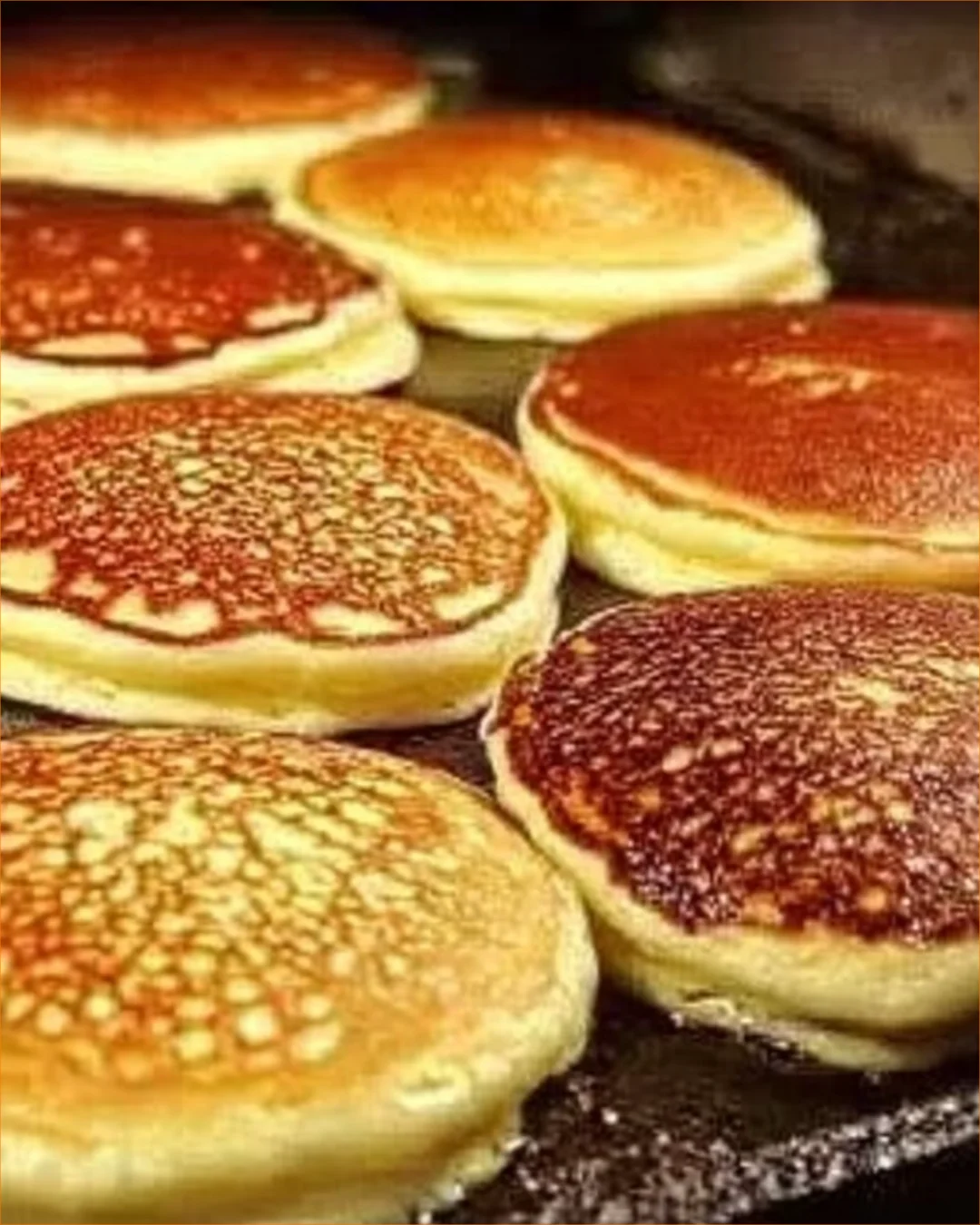 Stack of fluffy pancakes topped with syrup and fresh berries