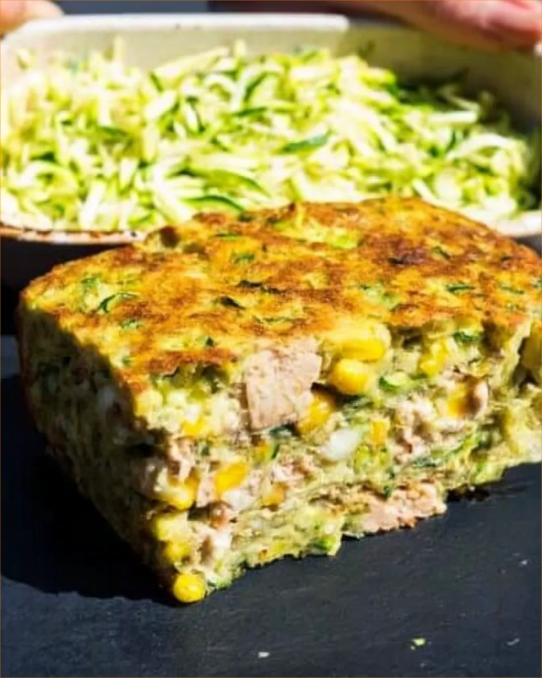 Zucchini Tuna Bake fresh out of the oven topped with cheese and herbs