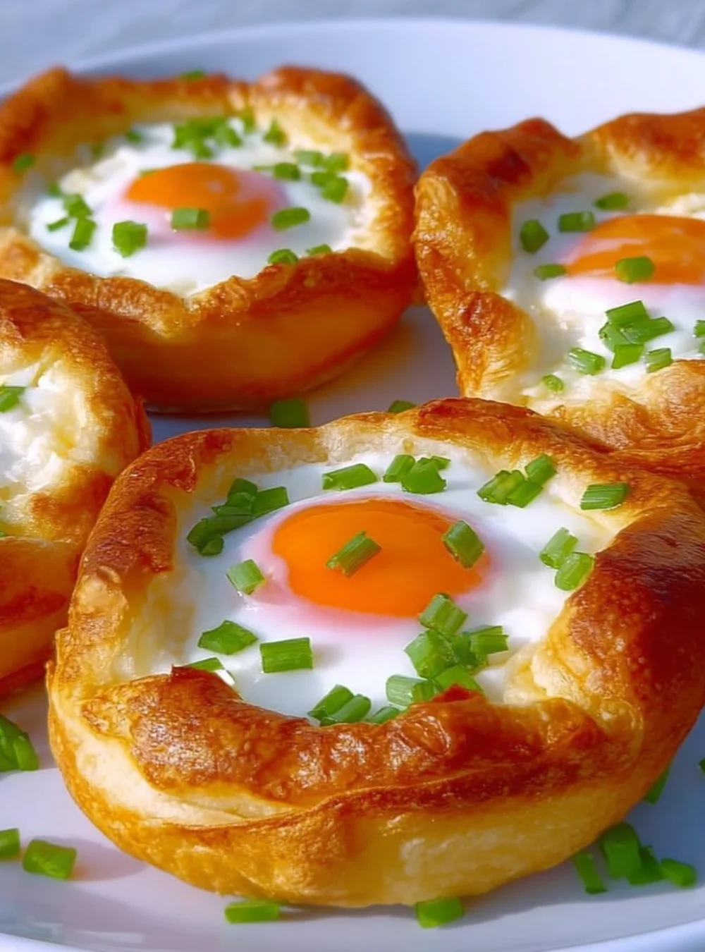 Flourless potato and egg nests served on a plate with fresh herbs.