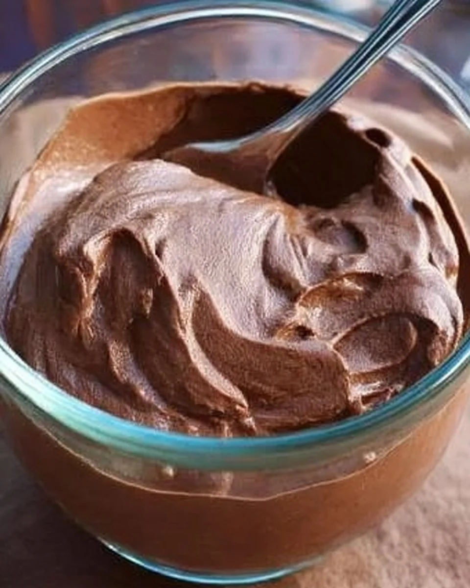 A bowl of secretly healthy chocolate pudding topped with fresh berries