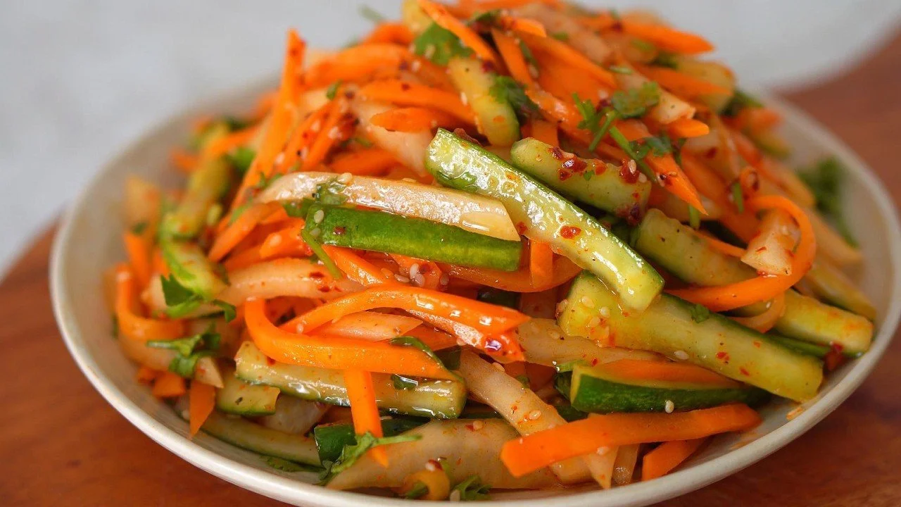 Cucumber Carrot Radish Salad with sesame dressing in a bowl